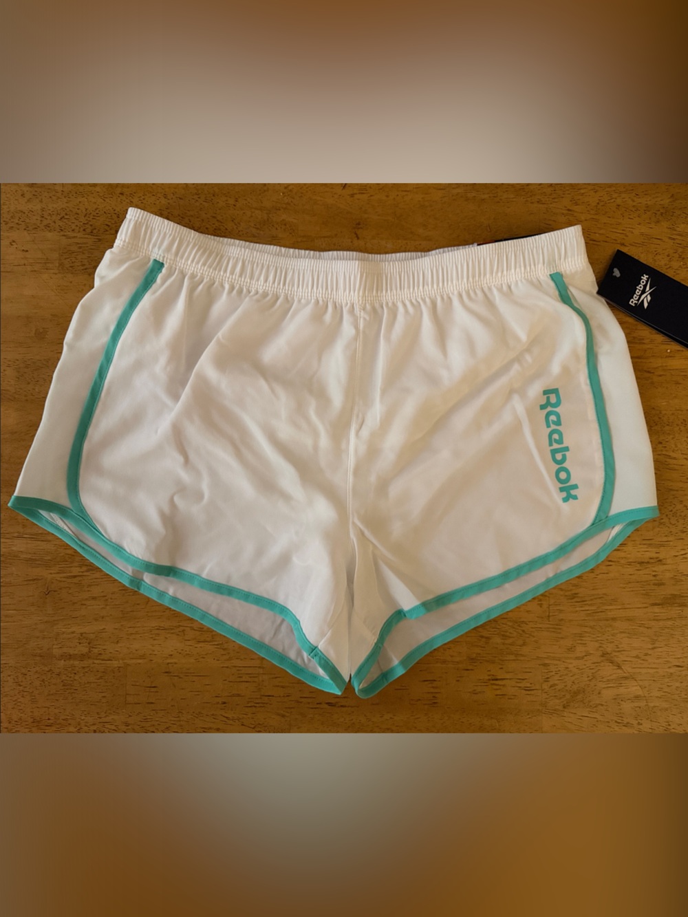 Women’s Reebok White Athletic Shorts with Teal Trim with Mesh Liner